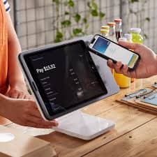 Customer paying by phone on a tablet POS